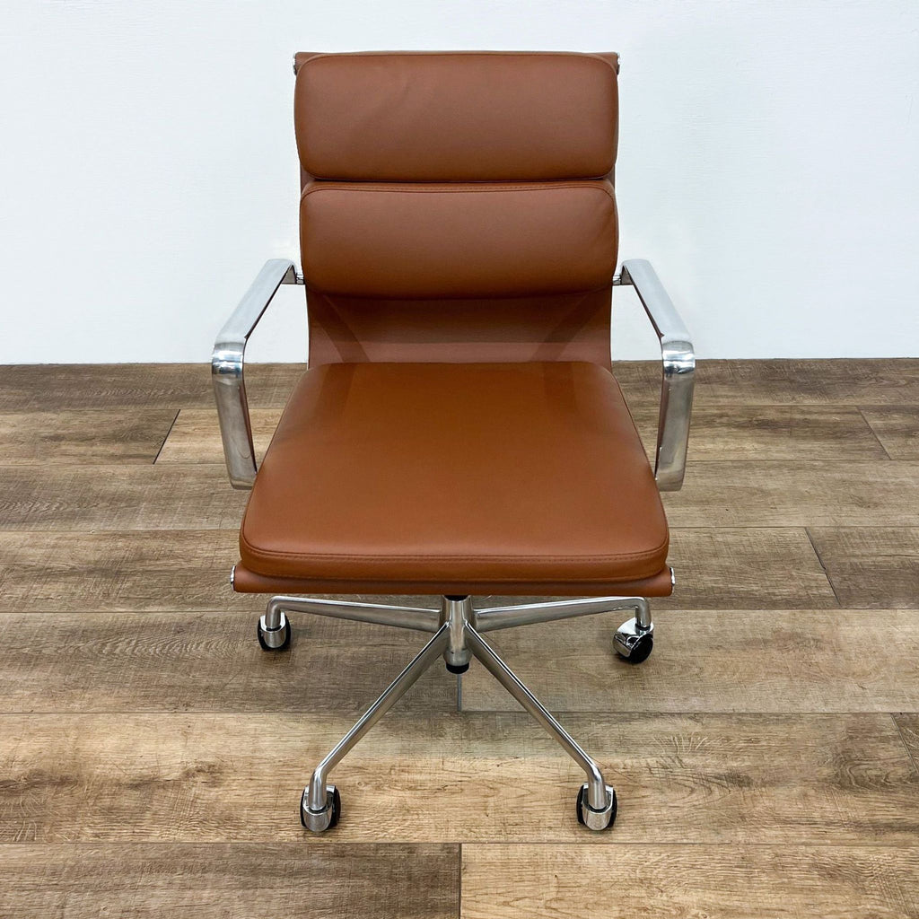 Angled view of the Soho Management Chair with padded seat and caster wheels.