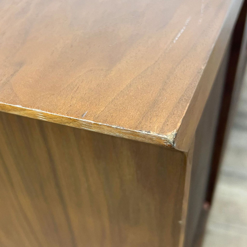 Close-up of Reperch sideboard showing minor surface damage on the corner.