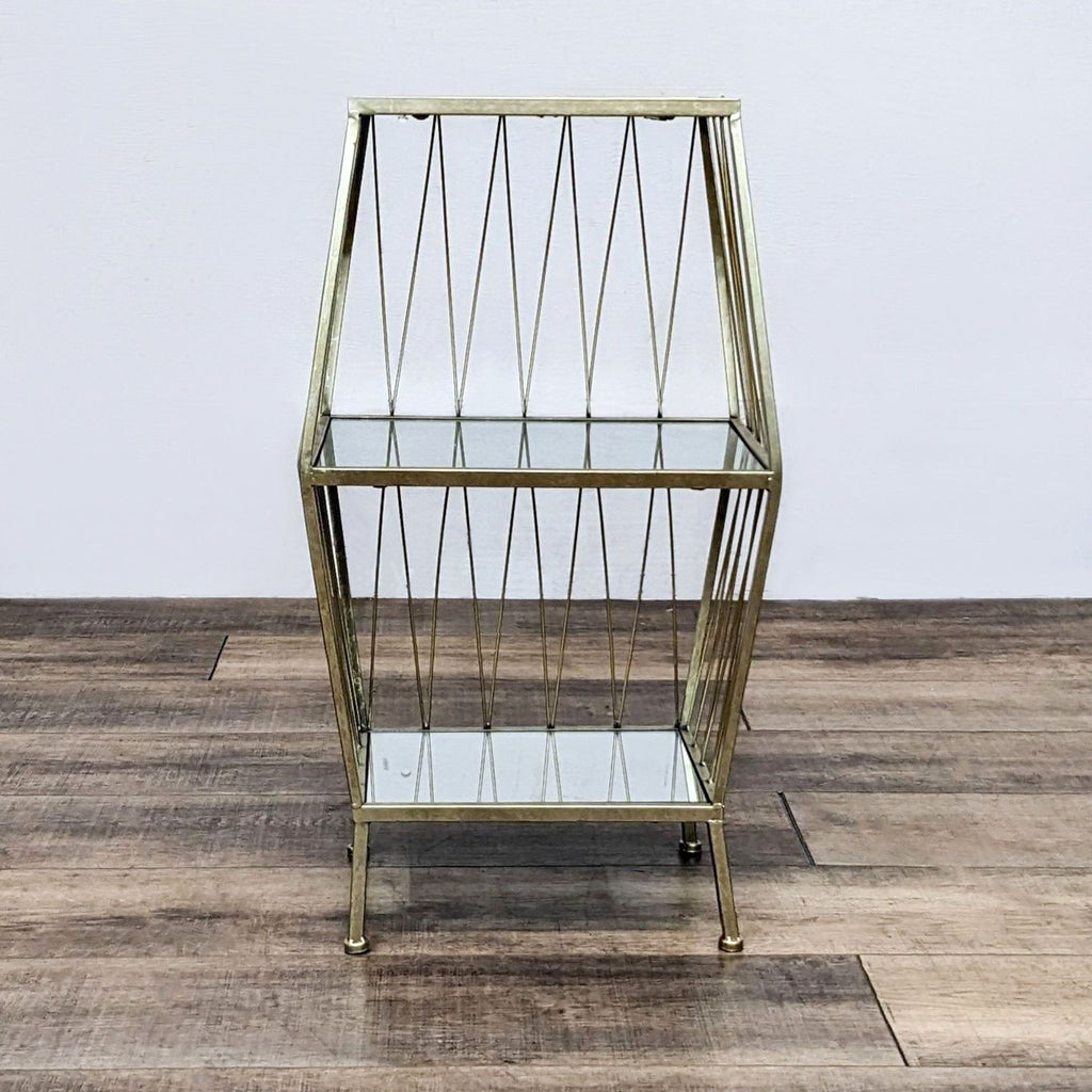 Geometric metal and glass shelving unit with a modern, open design on a brown wood surface.