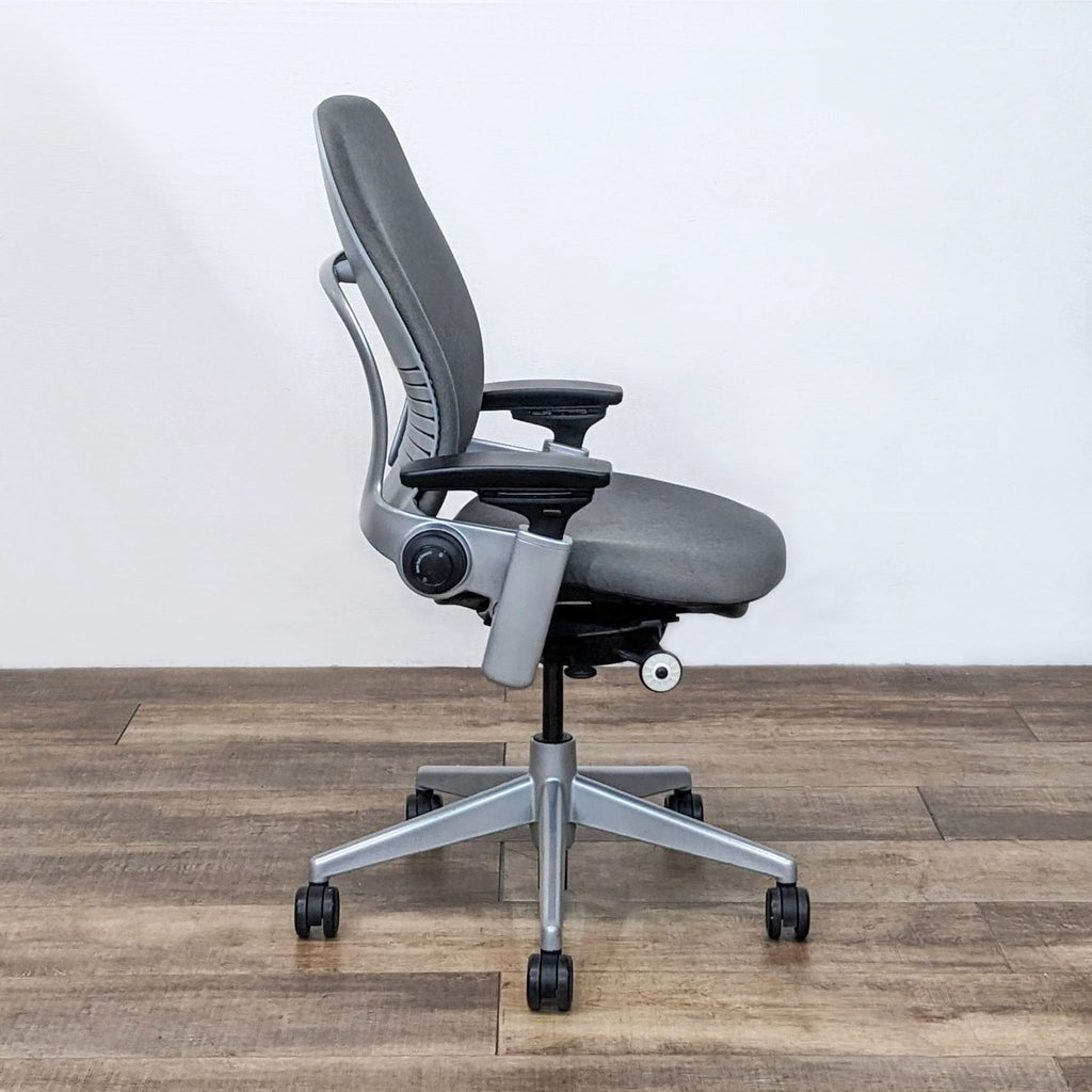 Steelcase Leap office chair in black with adaptive LiveBack and Natural Glide seat for flexible spine support.