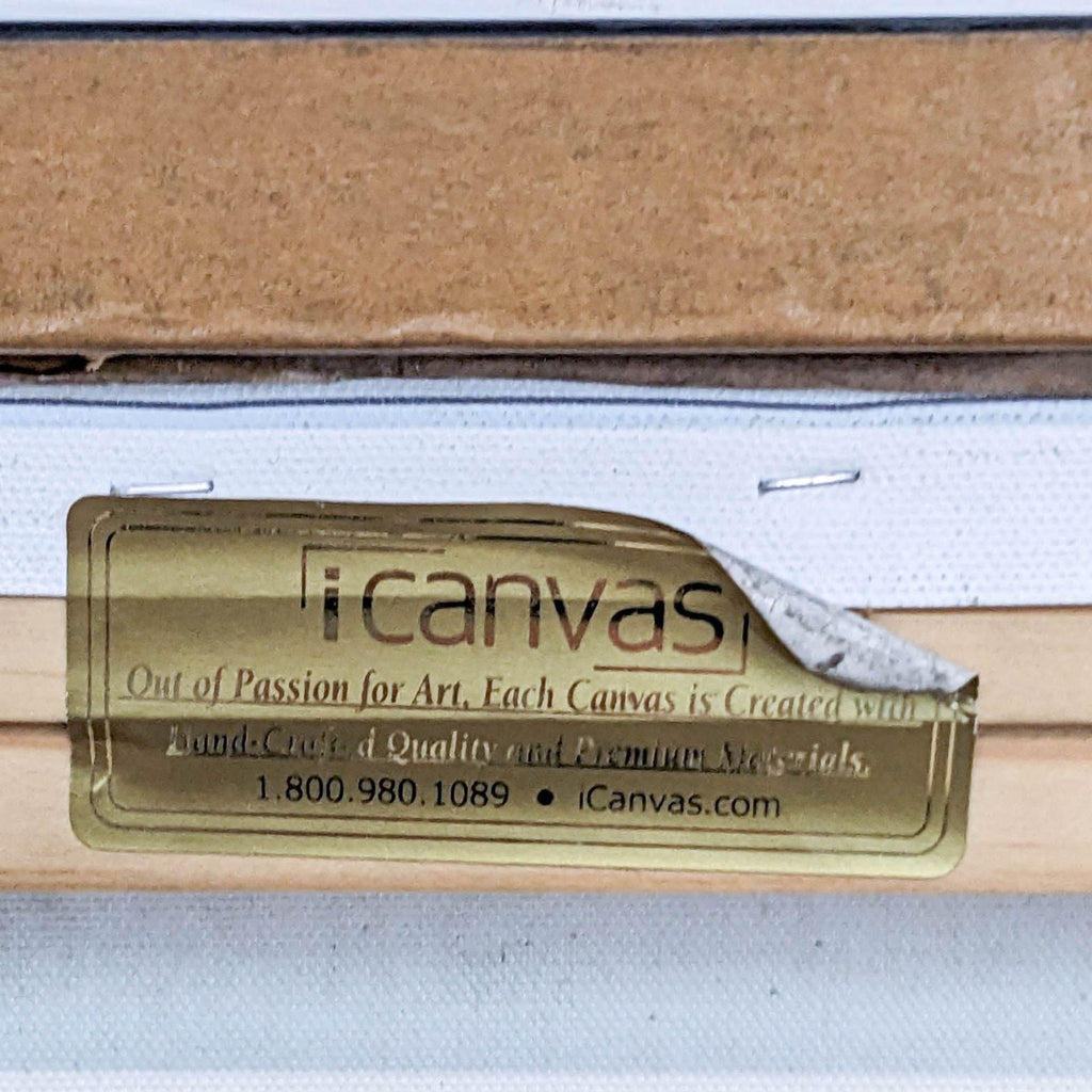 Close-up of iCanvas label on the back of a canvas, showing brand and quality promise.