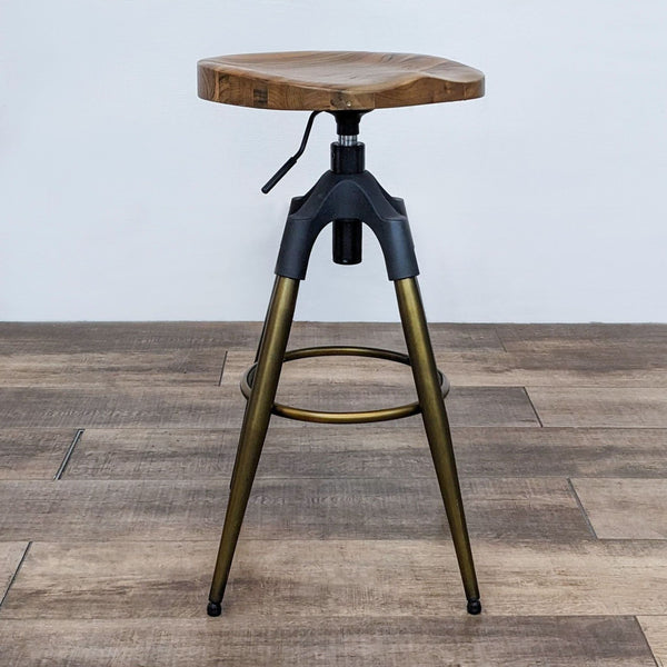 Solid wood stool with natural grain, black and gold frame, adjustable height.  