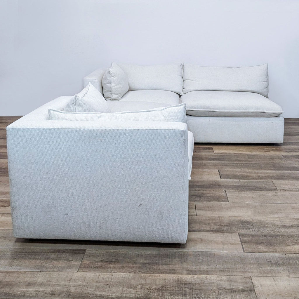 Reversible ivory fabric sectional displayed in a cozy room setting.