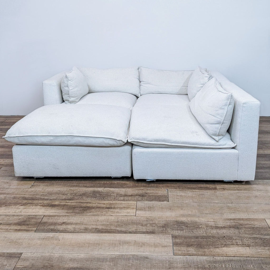 Creamy, four-piece modular sectional with removable, stain-resistant fabric.