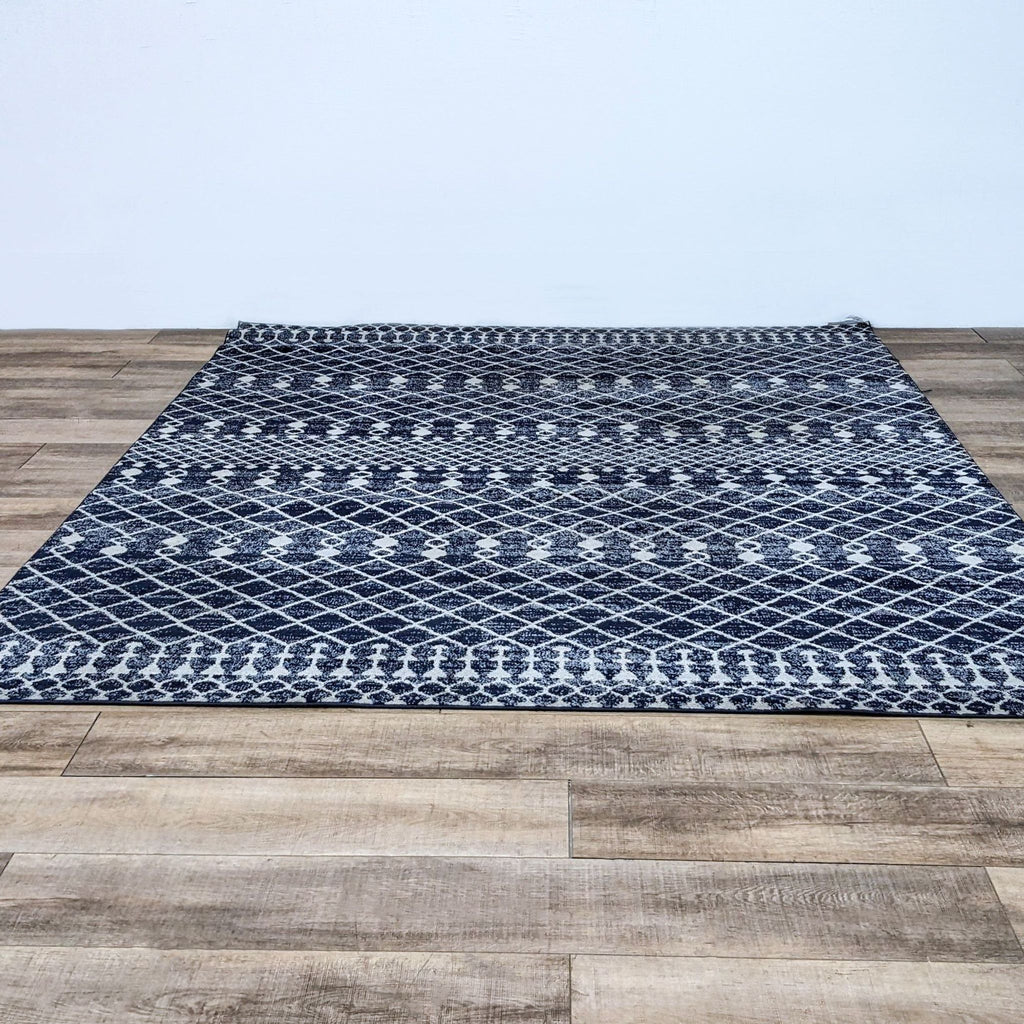 a white and black rug on a brick floor 