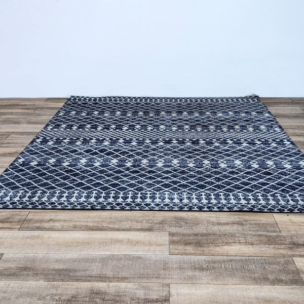 a white and black rug on a brick floor 