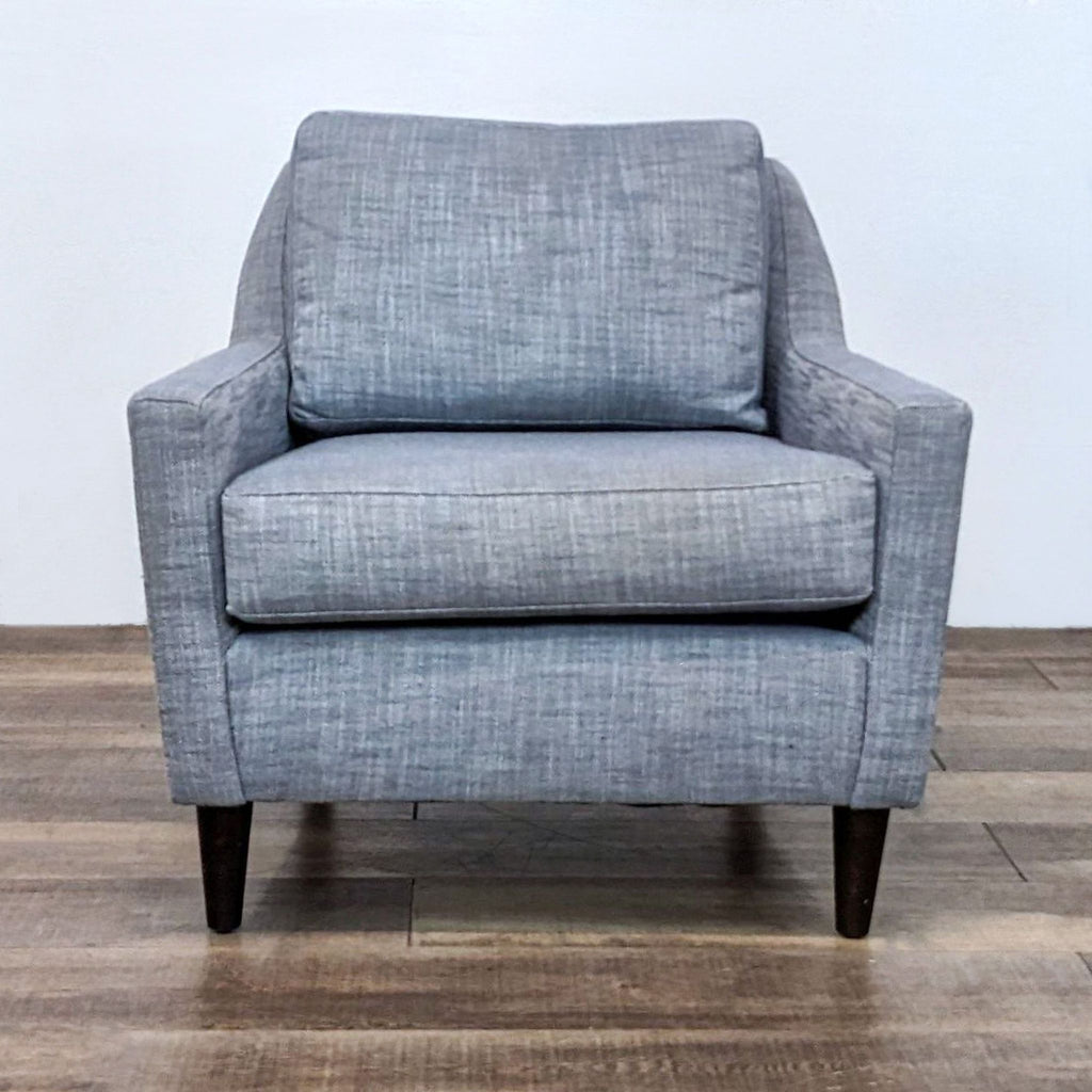 Front view of the blue upholstered Everett Chair with wood legs.