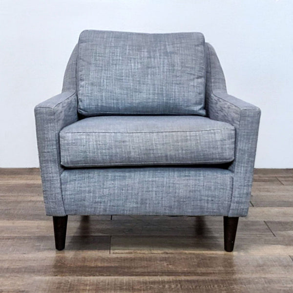 Front view of the blue upholstered Everett Chair with wood legs.