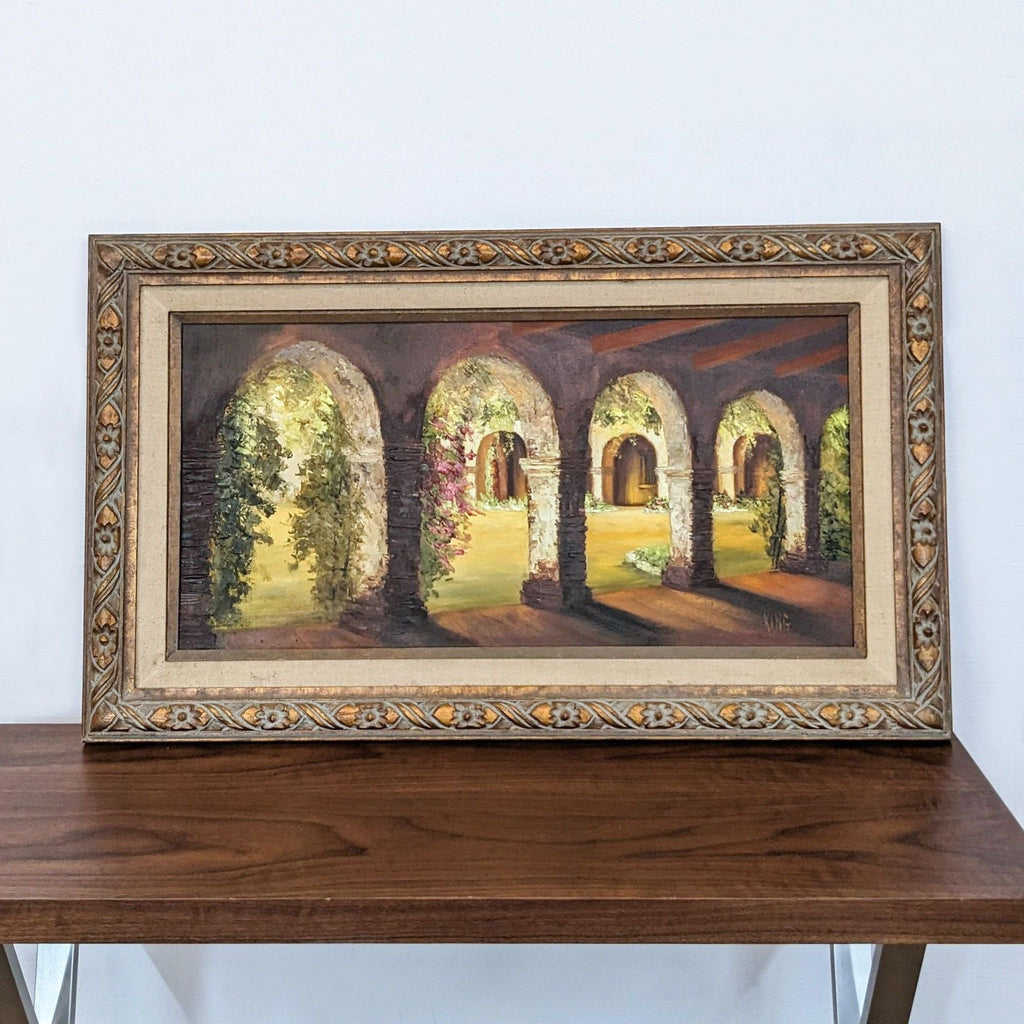 1. Framed painting of a sunlit courtyard with curved arches, greenery, and classic architectural details by artist King.
