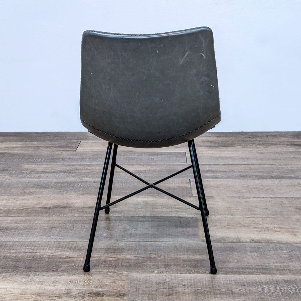 Back view of the Paxton dining chair highlighting the reinforced saddle stitching and sturdy base.
