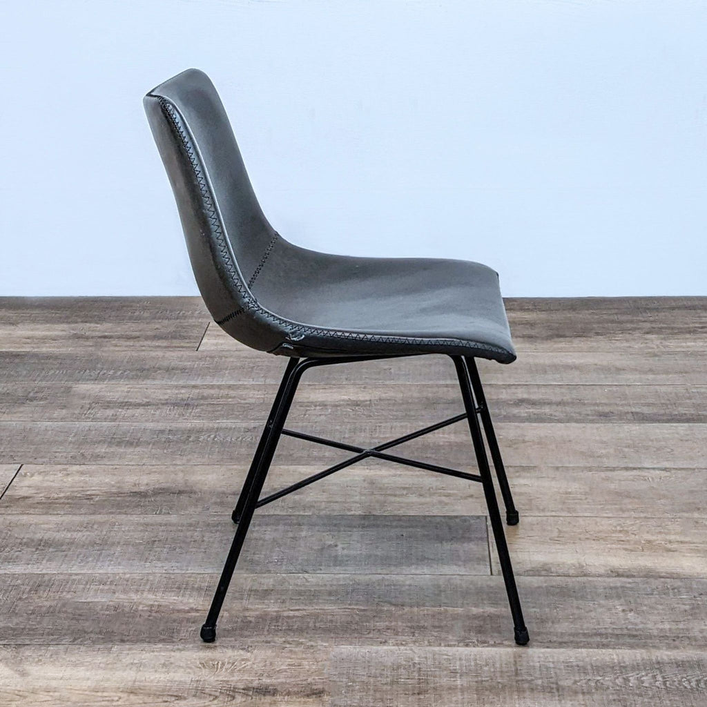 Side profile of the Paxton dining chair showcasing its modern lines and durable leatherette seat.