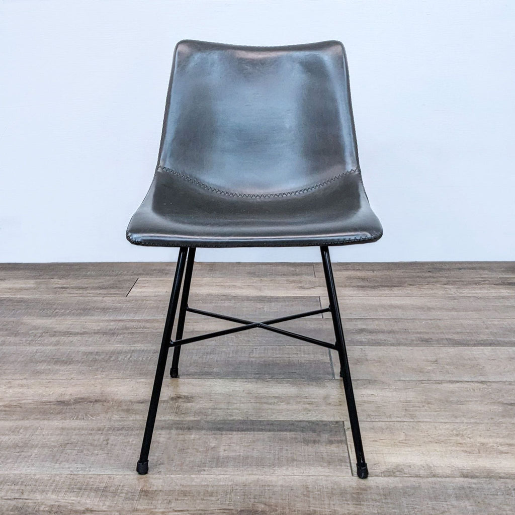 Front view of the Paxton dining chair with leatherette upholstery and matte black steel legs.