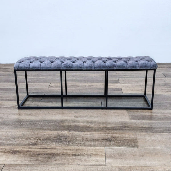 Tufted leather bench with a dark metal frame, perfect for modern interiors.
