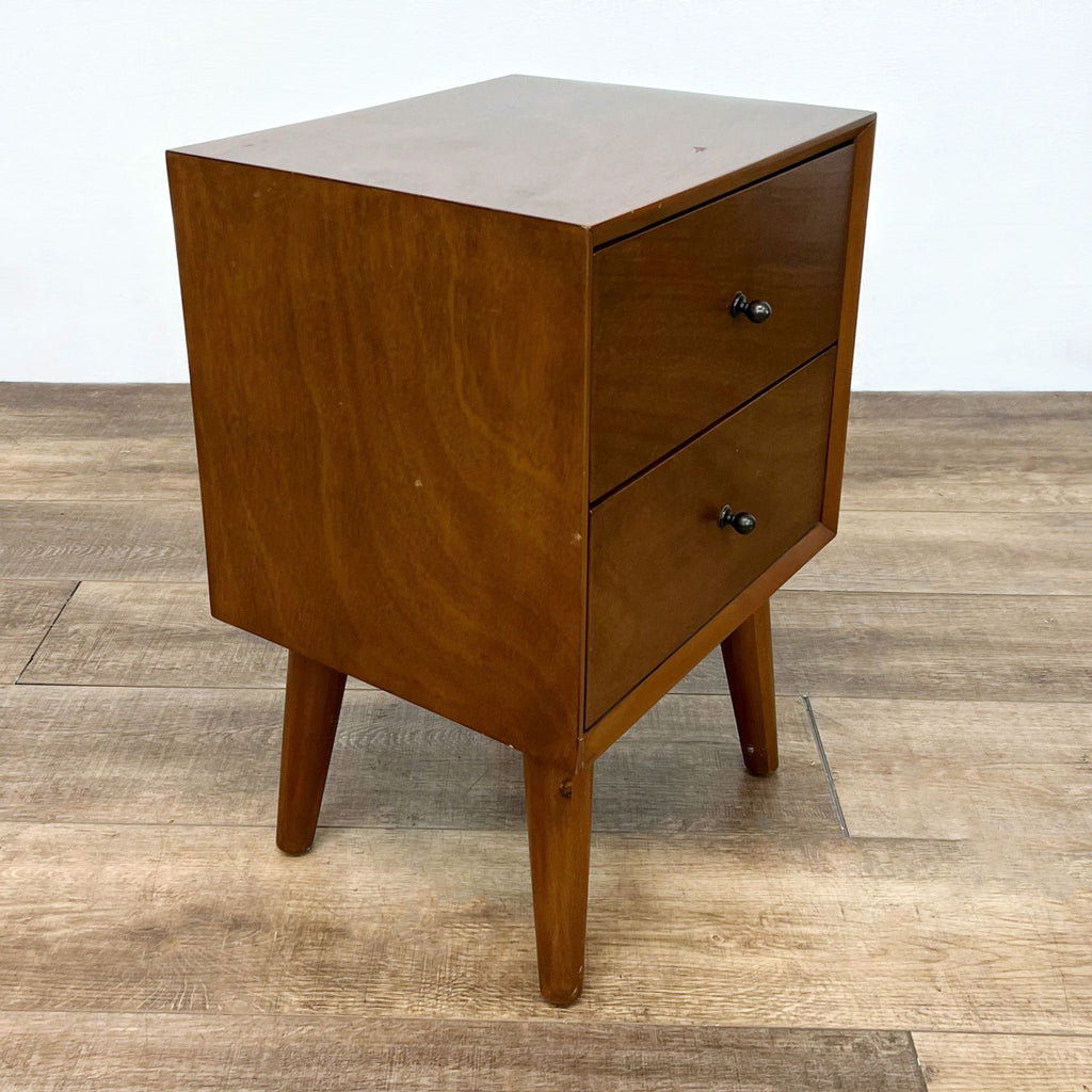 Side view of Reperch end table with drawers and angled legs.