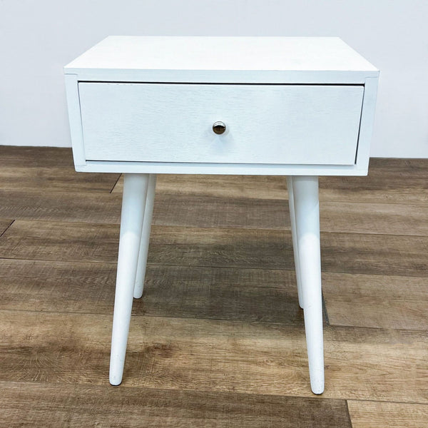 a white bedside table with a drawer and a drawer.