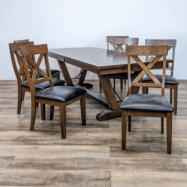 Bayside dining set with an extendable table and six X-back chairs in wood finish and black cushions.  