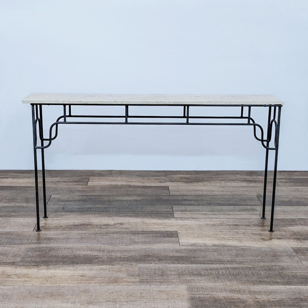 Reperch console table with elegant metal frame and stone top on wooden floor.