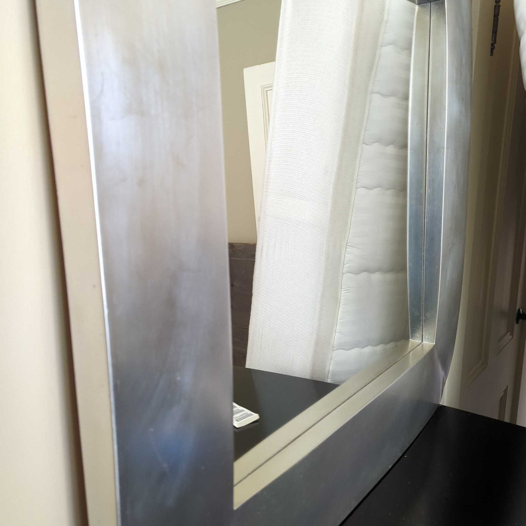 Minimalist circular mirror designed for wall mounting, suitable for bedrooms or hallways.