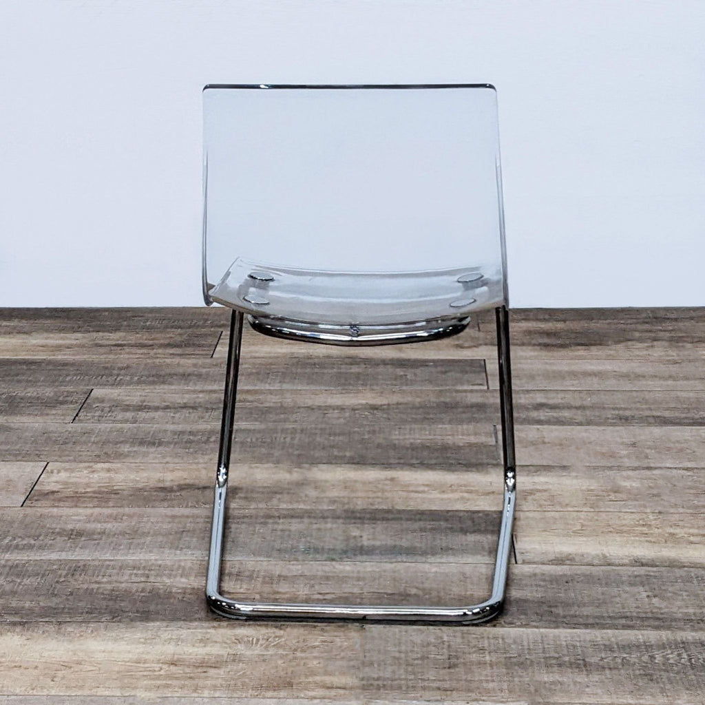 Front view of IKEA Tobias chair, transparent and reflective design.