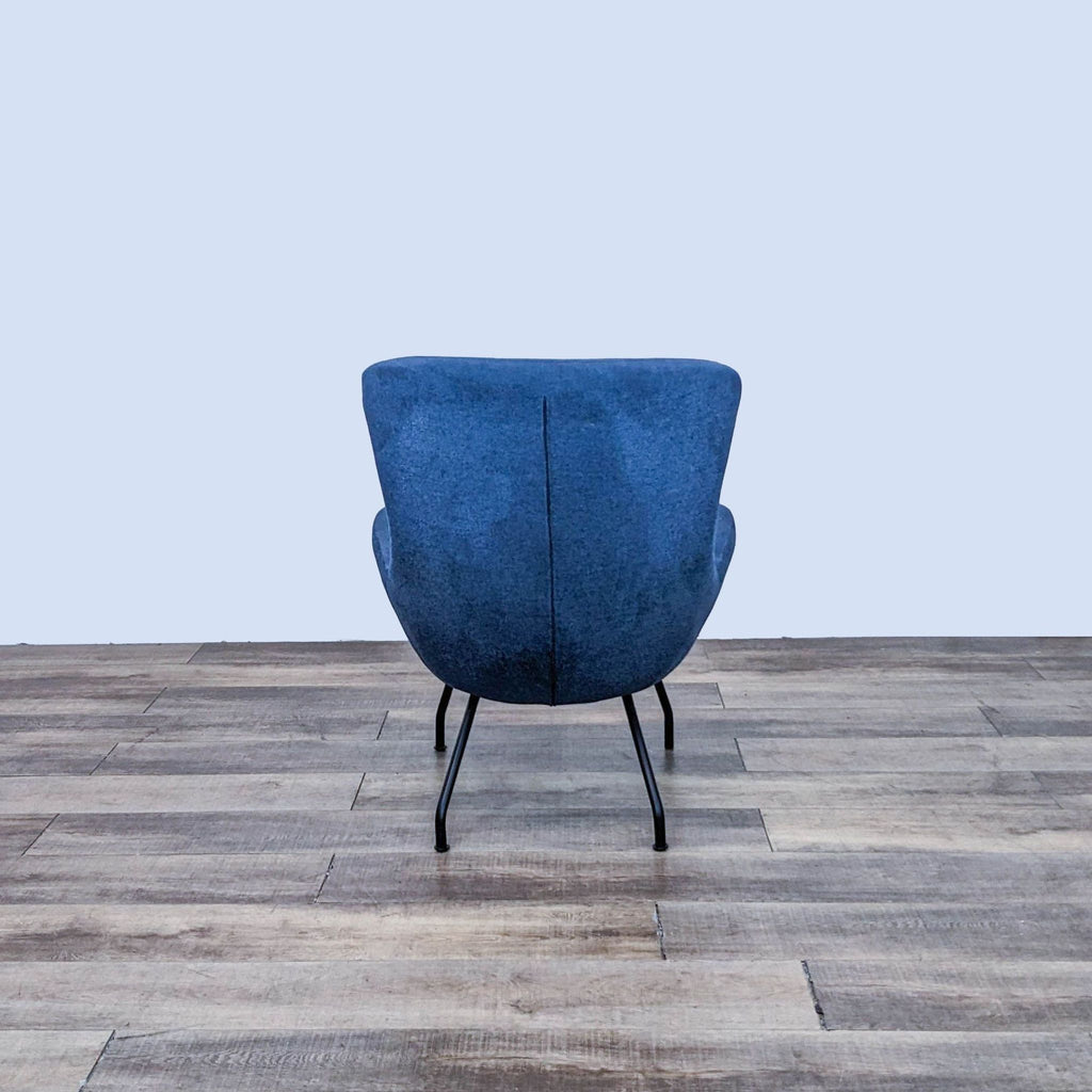 Rear view of the blue lounge chair highlighting textured upholstery.