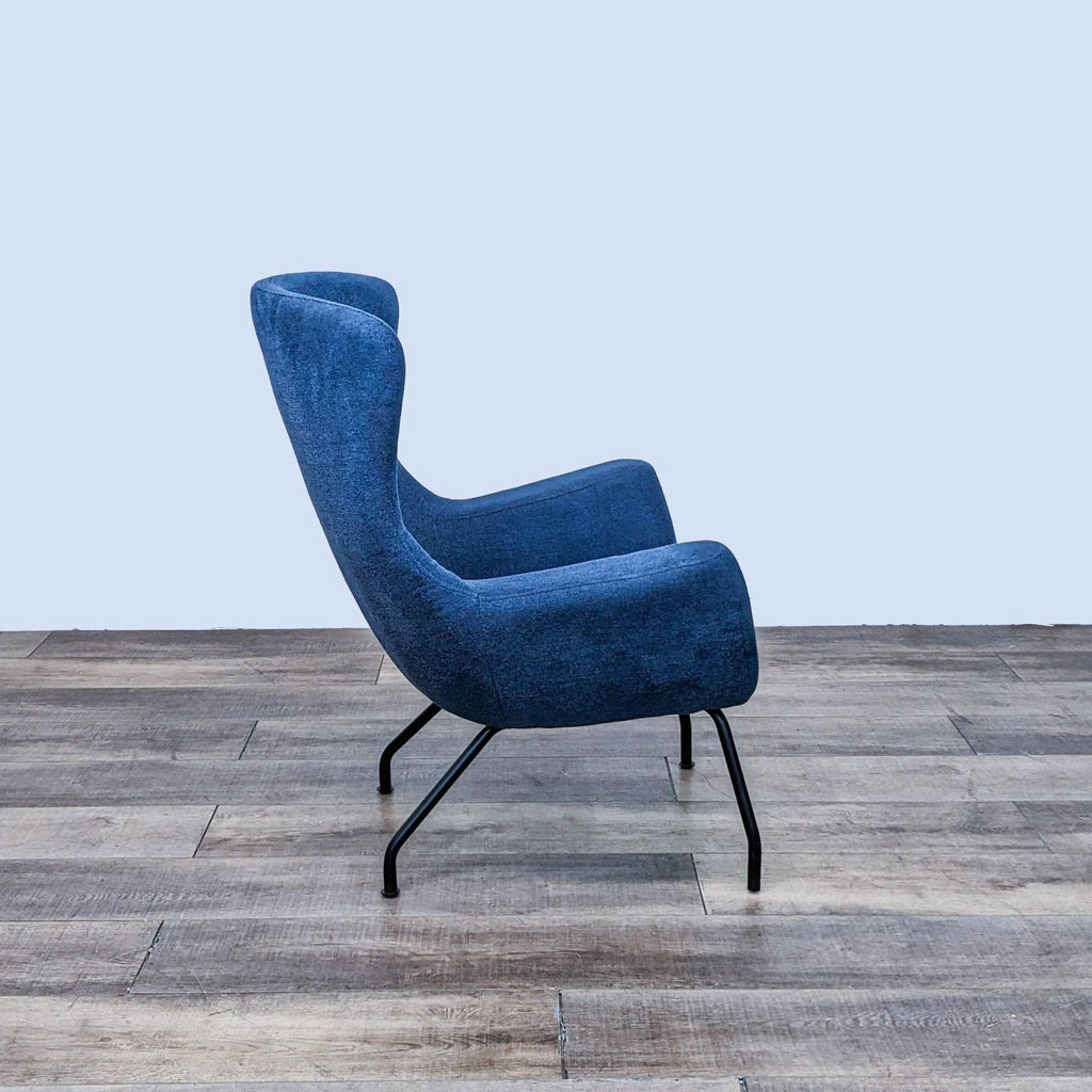 Side view of a blue lounge chair with curved lines and angled legs.