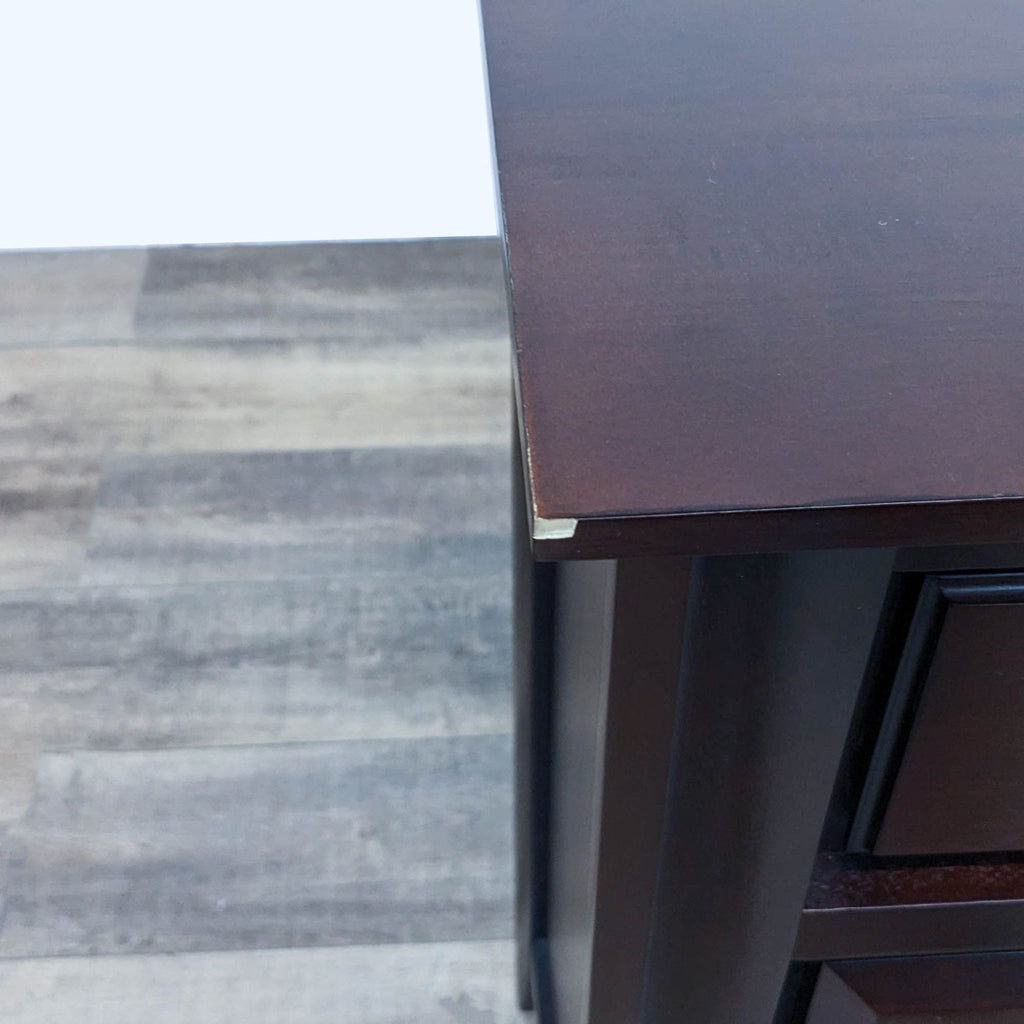 Close-up of the dresser's corner, highlighting wood texture.