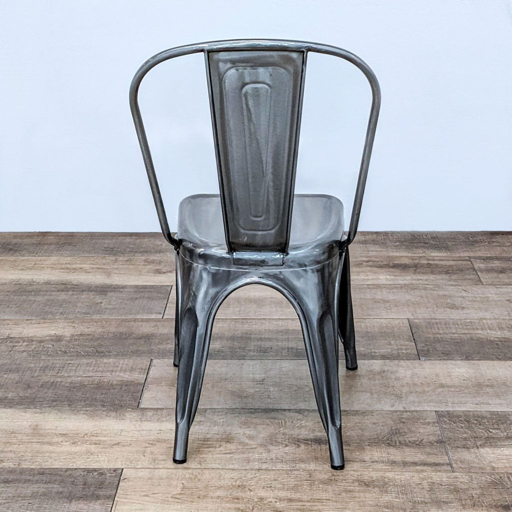 Industrial metal side chair with a tall back and slim legs, suitable for compact spaces.