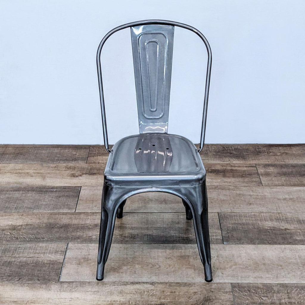 Stackable, lightweight metal chair with a curved back, perfect for versatile seating.