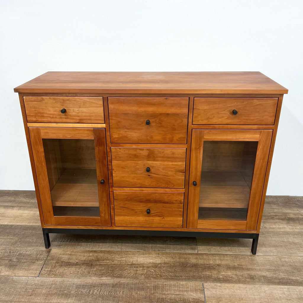 Front view of cherry cabinet with five drawers and metal base. Arts and Crafts inspired design.
