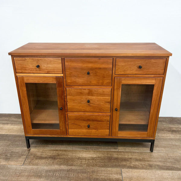 Front view of cherry cabinet with five drawers and metal base. Arts and Crafts inspired design.