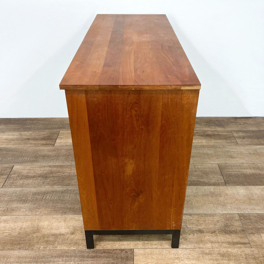 Side view of cherry Room and Board cabinet showcasing its sleek, handcrafted design and natural finish.