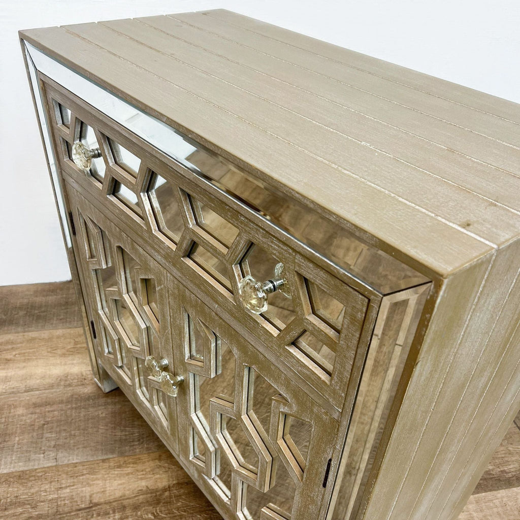 Reperch dresser with mirror inlays and geometric design on a whitewashed wooden frame.