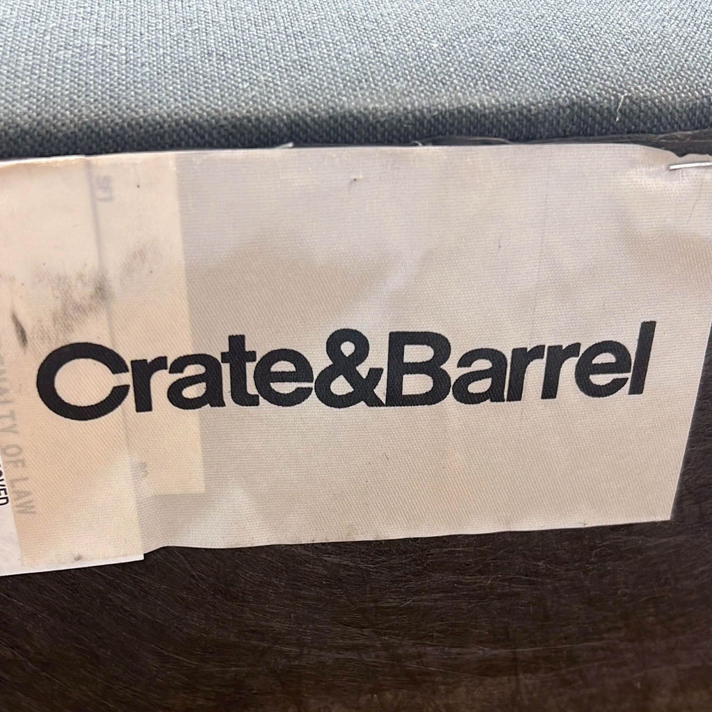 a crate & barrel logo on a piece of furniture.