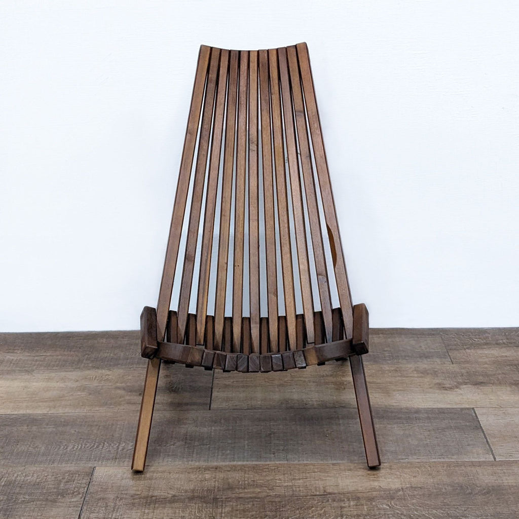 Solid teak folding chair with modern slatted design by Reperch.