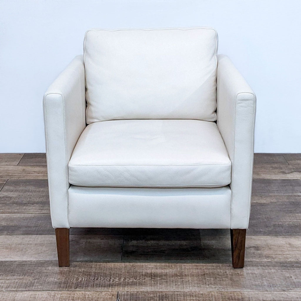 Front view of the Kent chair by Room & Board, white leather with walnut wood feet.