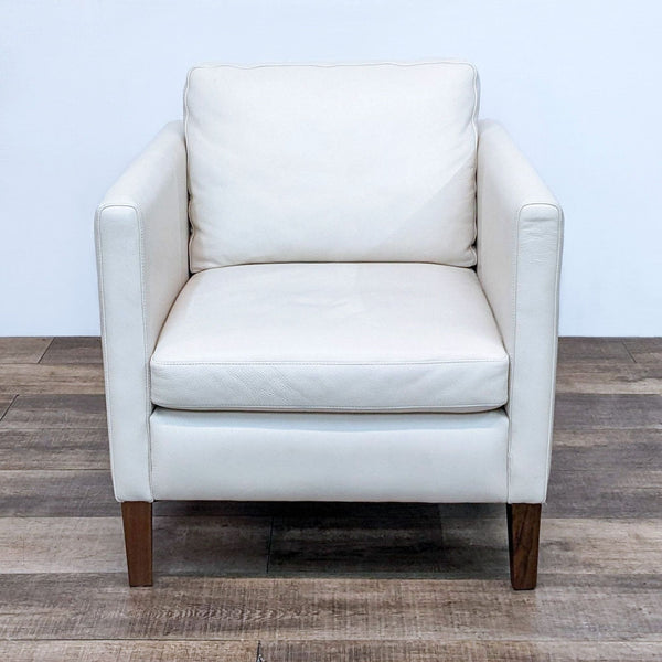 Front view of the Kent chair by Room & Board, white leather with walnut wood feet.
