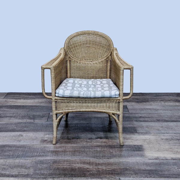 Contemporary wicker rattan armchair with cushion, front view.