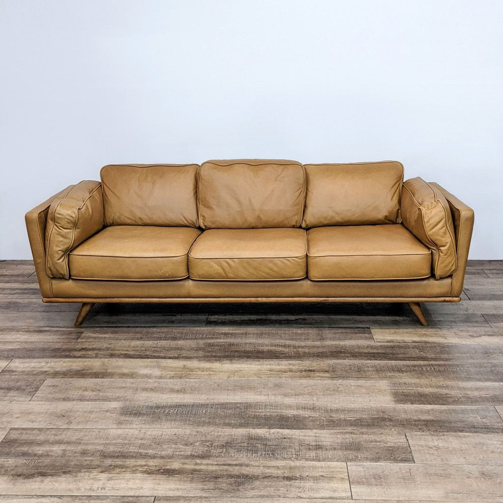 Reperch Charme tan leather 3-seat sofa with honey oak wood frame and cushioned inside arms.