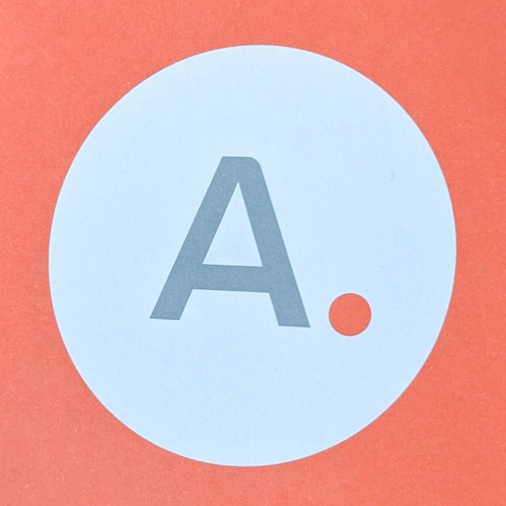 Closeup of a gray "A." in a white circle on an orange background.