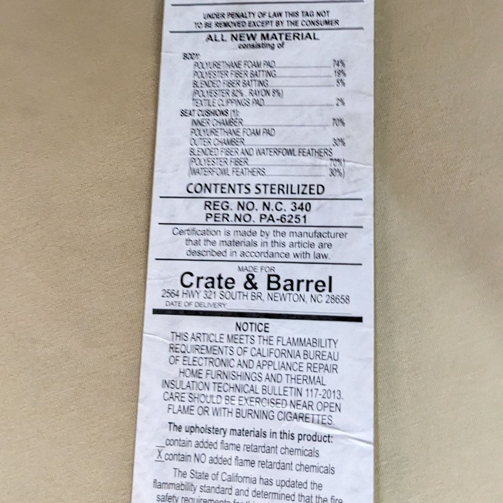 Crate & Barrel furniture tag detailing materials and safety compliance.