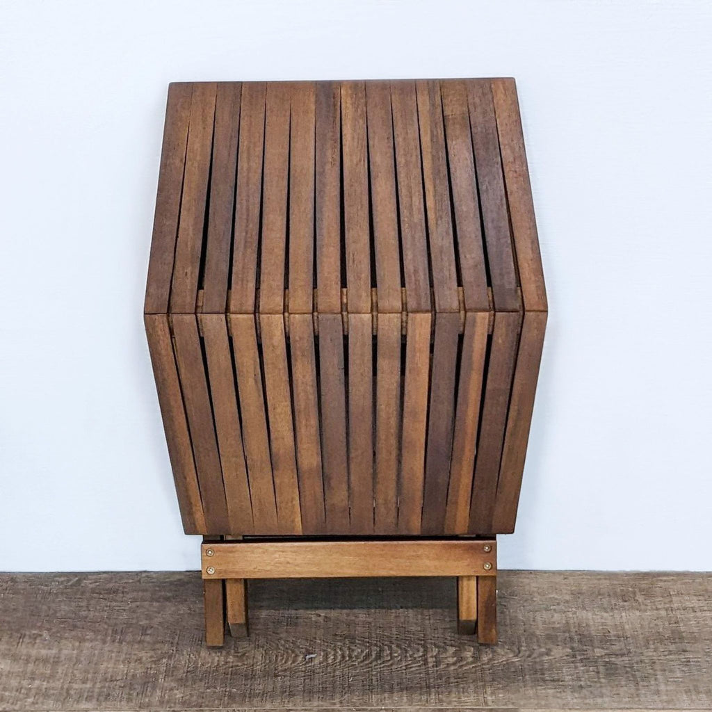 Reperch brand folding table from the Tables category, depicted folded upright to display its compact form.