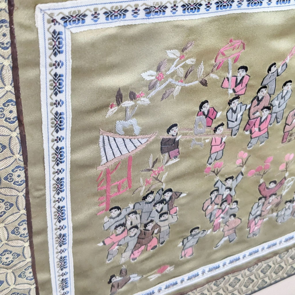 2. Close-up of embroidered parade with detailed figures on gold fabric.