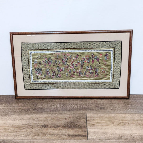 1. Framed Asian embroidered art on gold fabric with a parade scene.