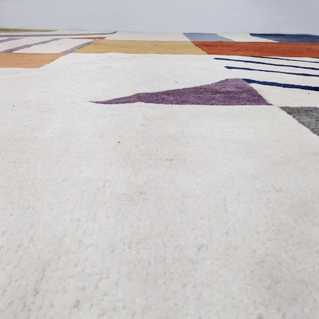 Side view of Safavieh's pure wool rug, highlighting its textured Art Deco design and colorful blocks.