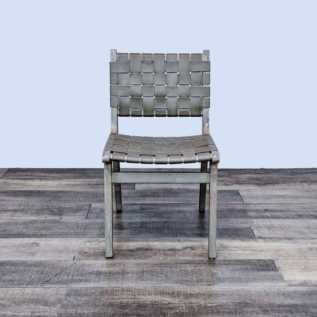 The Fenton chair with woven buffalo hide and acacia wood frame, showcasing midcentury design.