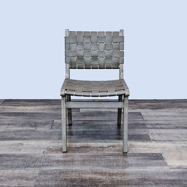 The Fenton chair with woven buffalo hide and acacia wood frame, showcasing midcentury design.