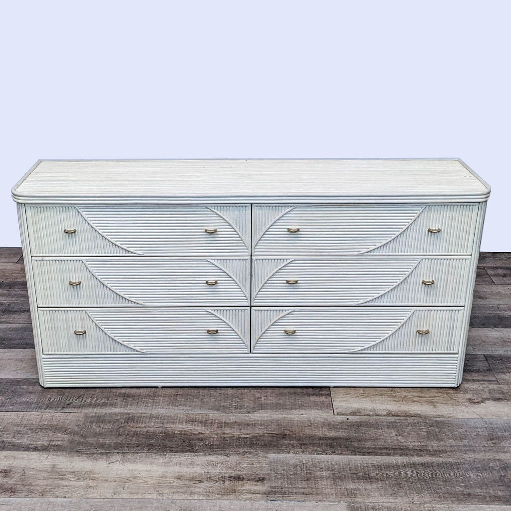 Front view of Coastal Furniture dresser with decorative design.