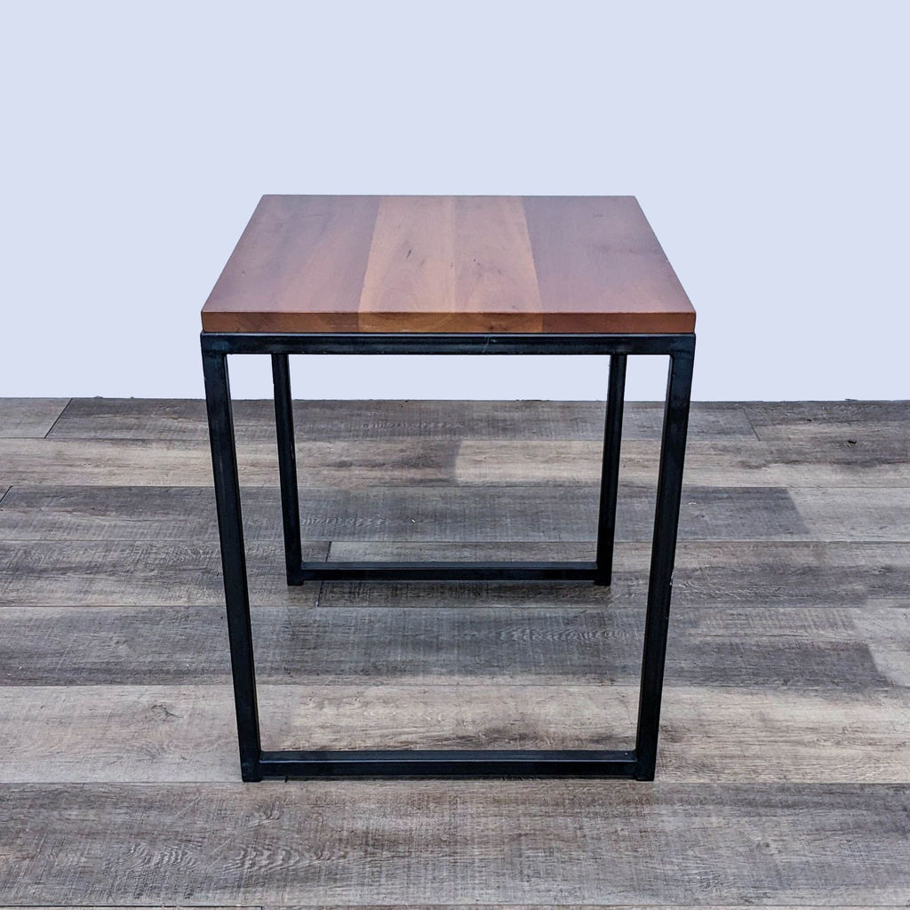Square end table from Reperch featuring a wooden top and metal base.