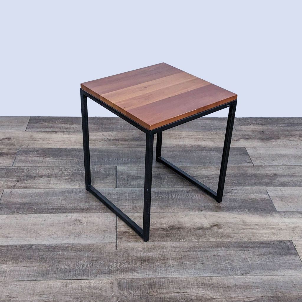 Reperch end table with a metal frame and flat wooden surface.