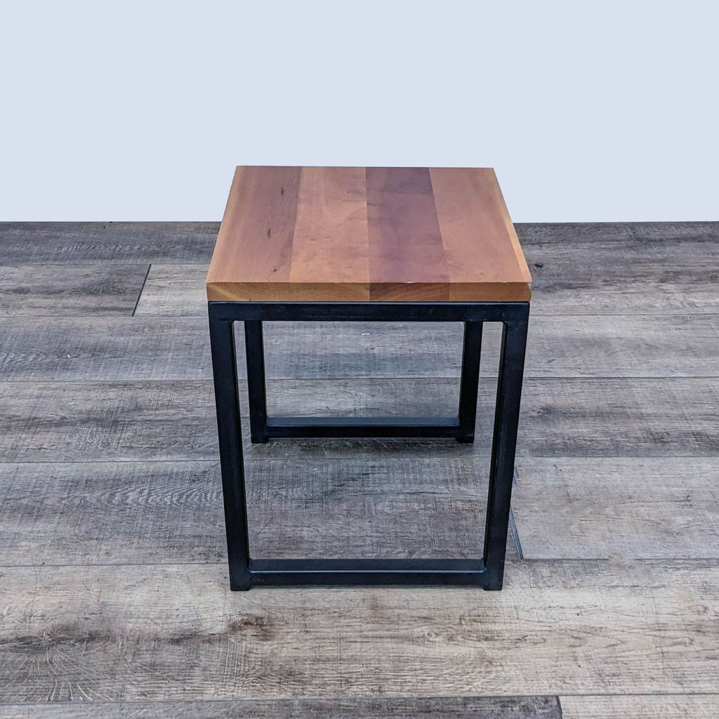 Reperch console table with wood surface and sturdy metal legs.